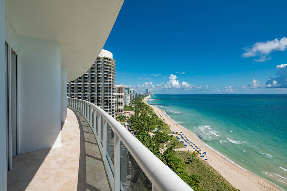 View from a condominium balcony showing the beach and ocean